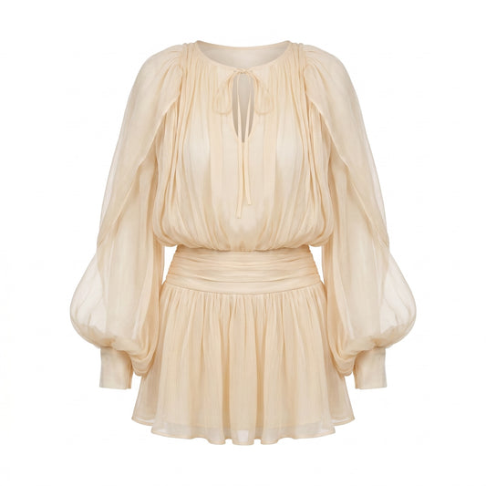 Exotica champagne sheer mini dress with voluminous bishop sleeves, cinched waist, and tie-neck detail.