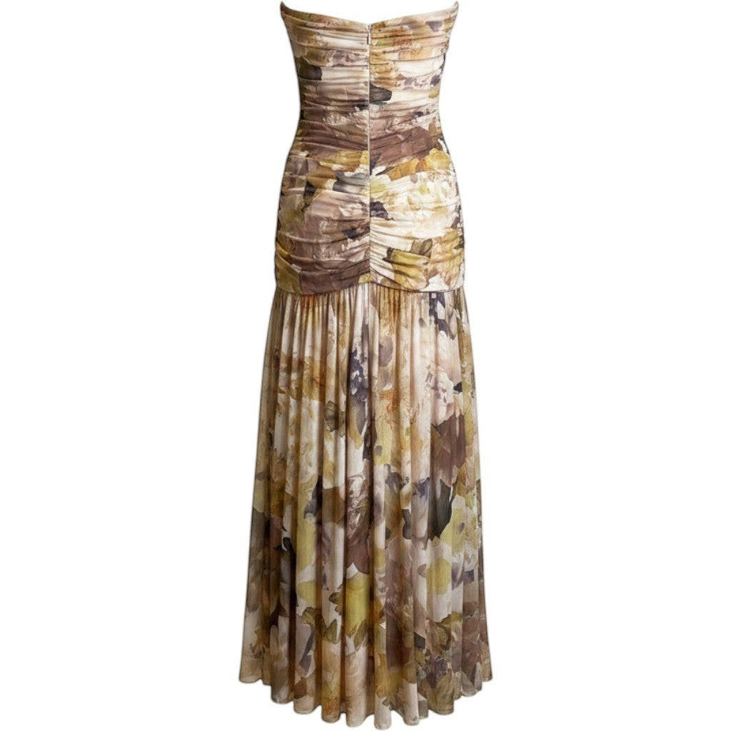 Vestido largo de fiesta Exotica palabra de honor con estampado floral en tonos tierra, ocre y dorado y falda fluida.